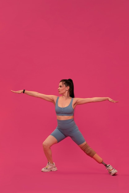 Portrait of disabled woman with prosthetic leg working out