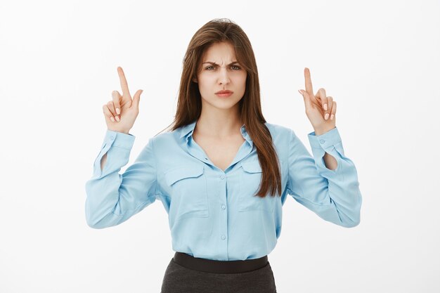 Portrait of disappointed brunette businesswoman posing in the studio