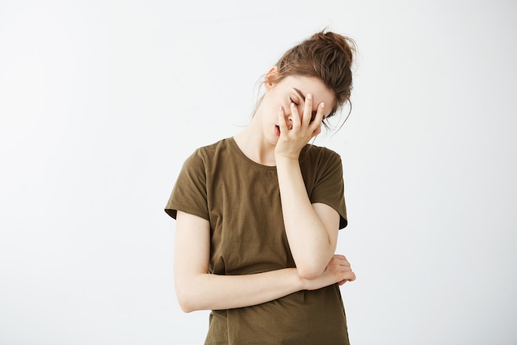 Free Photo portrait of displeased bored tired woman with bun.