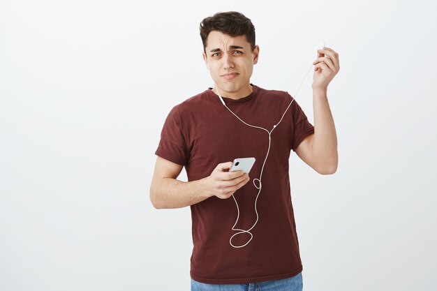 Portrait of displeased shocked attractive man in casual outfit