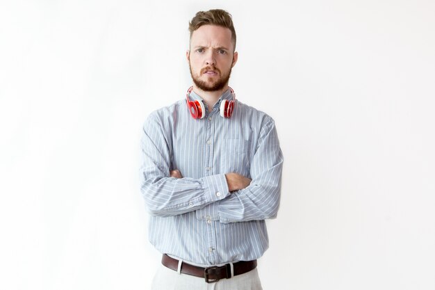 Portrait of displeased young man in headphones