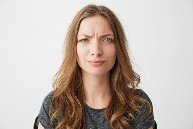 Portrait of displeased young pretty girl with contempt .