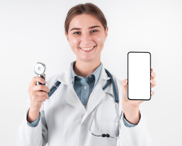 Portrait of doctor holding mobile phone