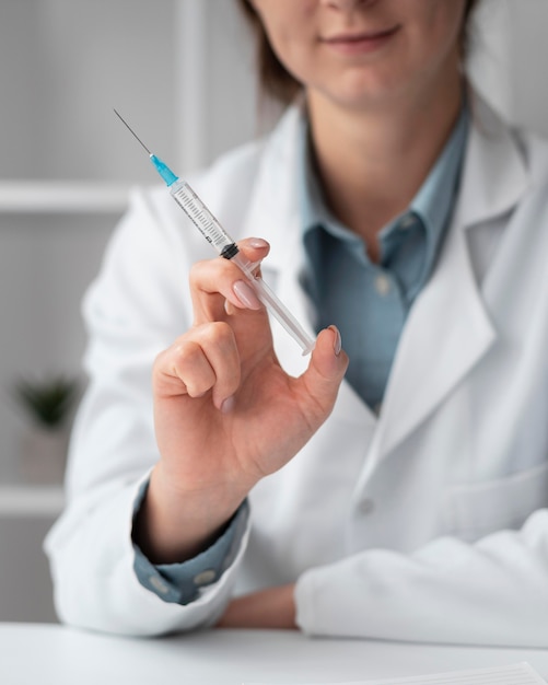 Portrait of doctor holding syringe