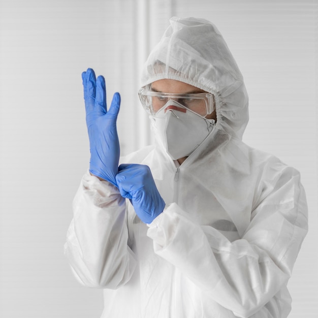 Portrait of a doctor wearing a face mask and surgical gloves
