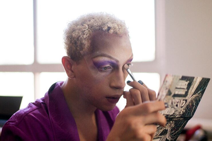 Free Photo portrait of drag man putting on makeup