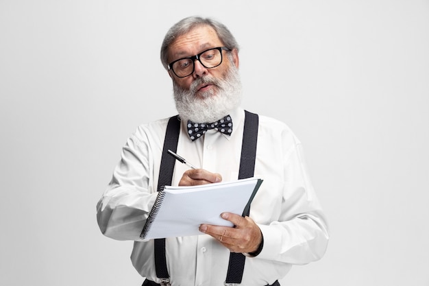 Portrait of elder man professor posing isolated on white