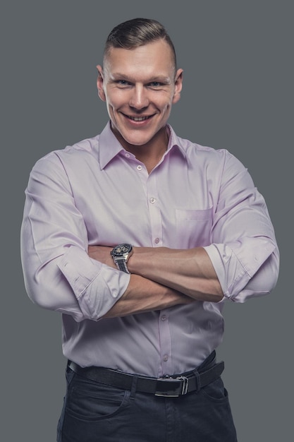 Portrait of elegant male in a shirt isolated on a grey background.