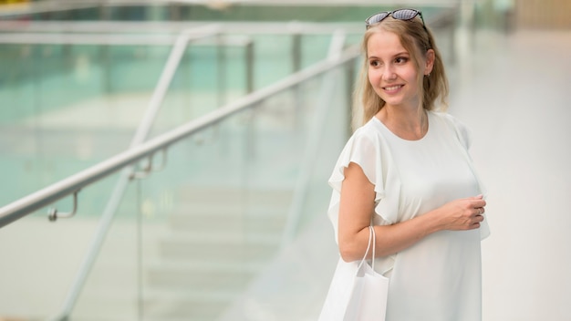 Portrait of elegant woman carrying shopping bags