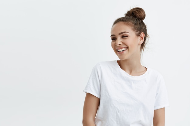 Portrait of emotive good-looking caucasian woman laughing while looking aside