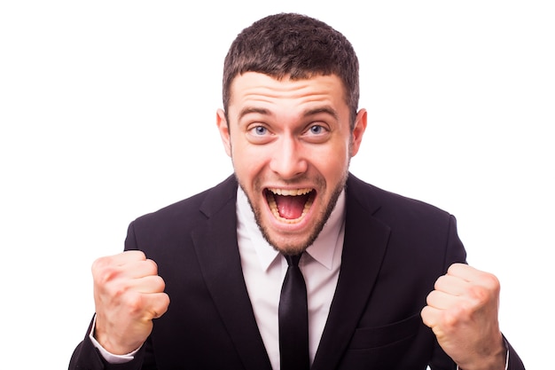 Portrait of a energetic young business man enjoying success, screaming against white - Isolated