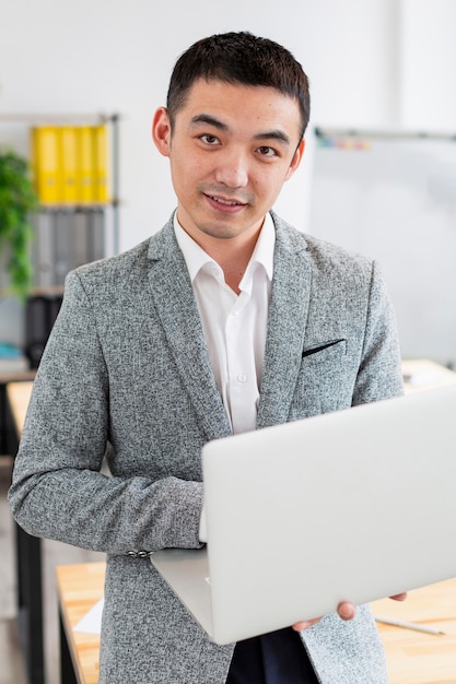 Portrait of entrepreneur holding laptop