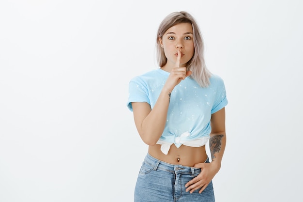 Portrait of excited blonde girl posing in the studio