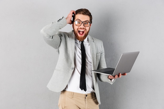 Portrait of an excited businessman dressed in suit