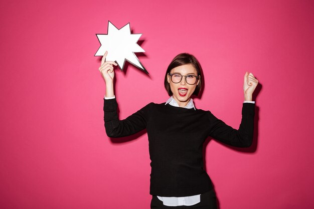 Portrait of an excited cheerful businesswoman with exclamation speech bubble