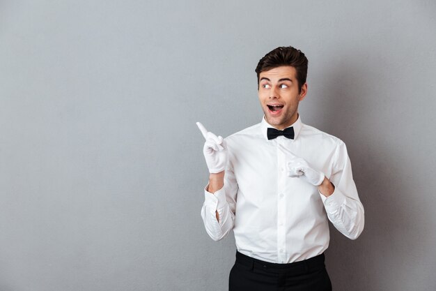 Portrait of an excited cheerful male waiter