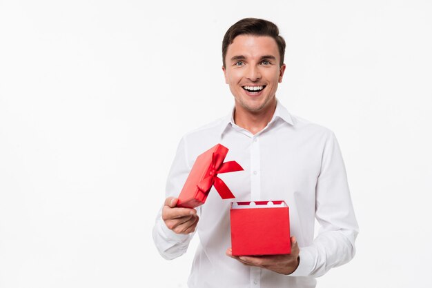 Portrait of an excited cheerful man in white shirt