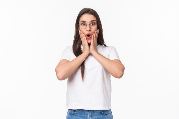 portrait of excited curious brunette caucasian woman in glasses