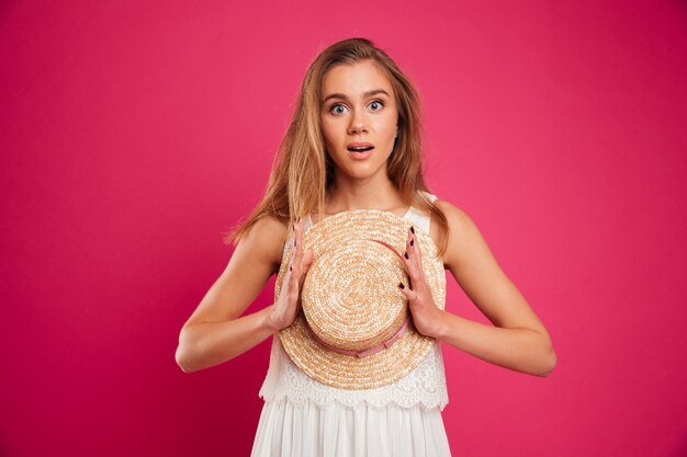 Portrait of an excited cute girl dressed in summer dress