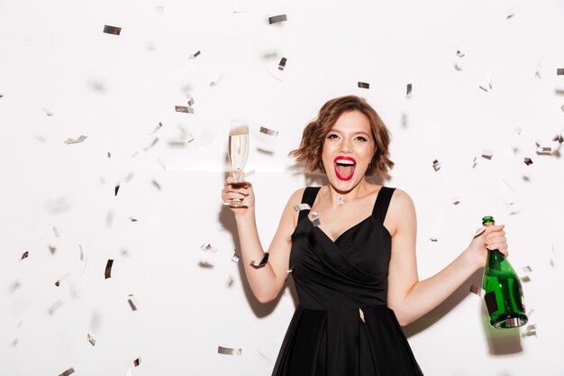 Portrait of an excited girl dressed in black dress