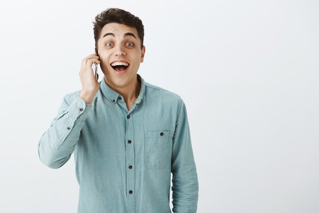 Portrait of excited happy european man in casual shirt