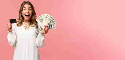 Free photo portrait of excited happy goodlooking blond girl in white dress winning money placed good bet made d