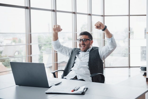 Portrait of an excited impressed funny banker manager at the office.