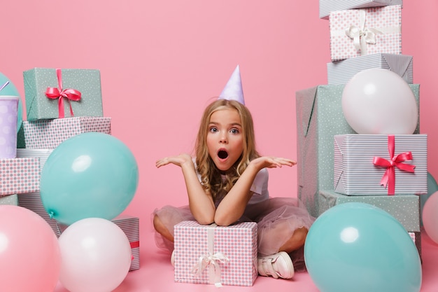 Portrait of an excited little girl in a birthday hat