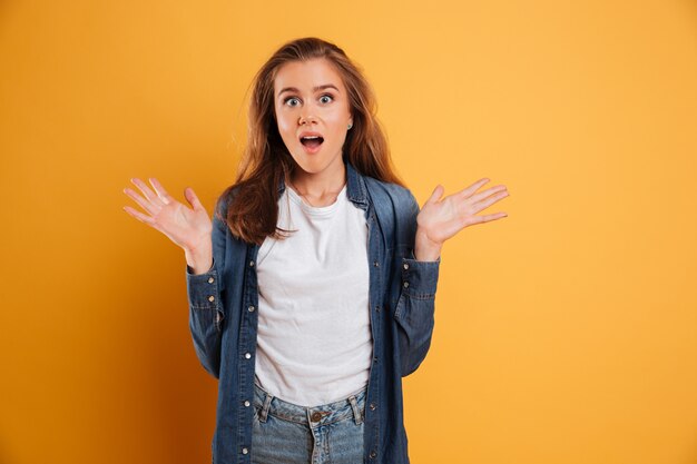 Portrait of an excited pretty girl looking surprised