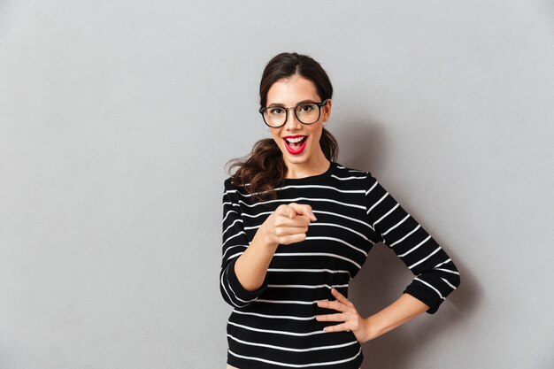 Portrait of an excited woman in eyeglasses