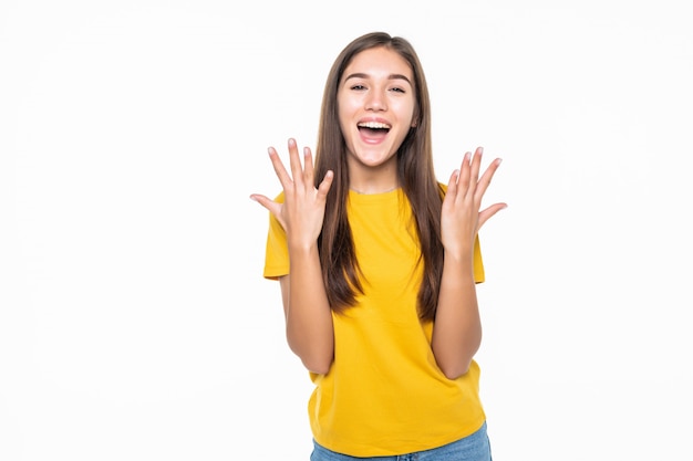 Portrait of a an excited young woman celebrating success over white wall