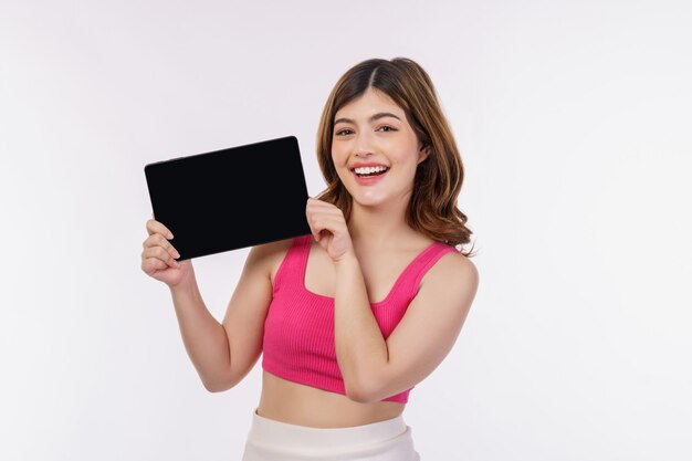 Portrait of excited young woman holding tablet mock up isolated over white background