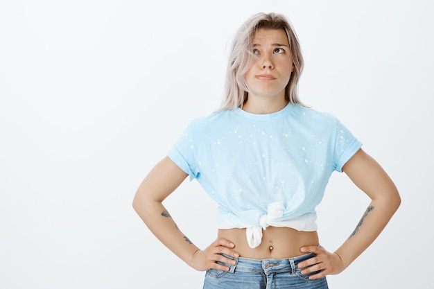 Portrait of exhausted beautiful blonde girl posing in the studio