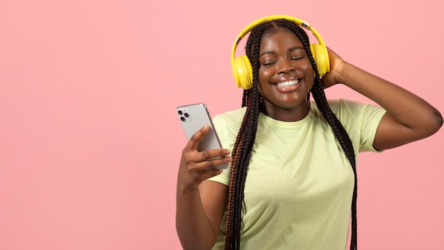 Portrait of expressive african american woman listening to music