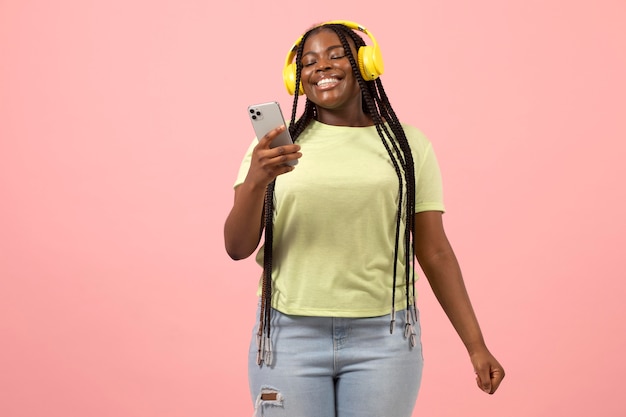 Portrait of expressive african american woman listening to music