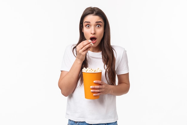 portrait expressive young woman eating popcorn