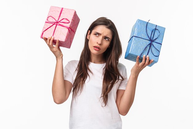 portrait expressive young woman holding gifts