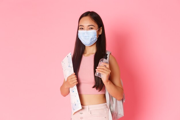 Portrait expressive young woman holding map and wearing mask