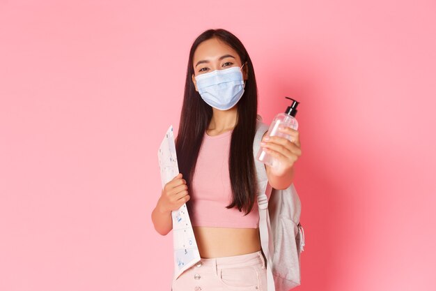 Portrait expressive young woman holding map and wearing mask