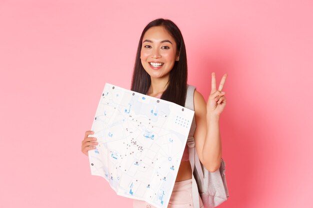 Portrait expressive young woman holding map