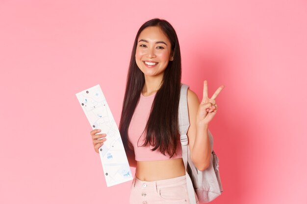 Portrait expressive young woman holding map