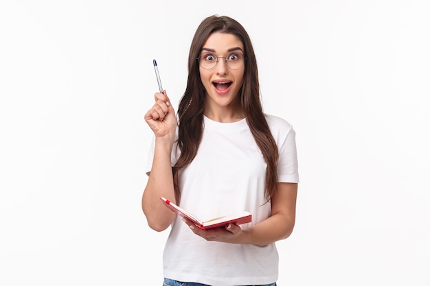 portrait expressive young woman holding notebook