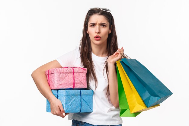 portrait expressive young woman holding shopping bags