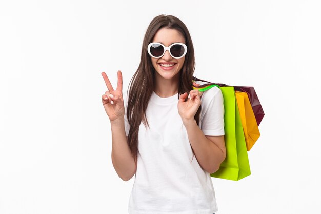portrait expressive young woman holding shopping bags