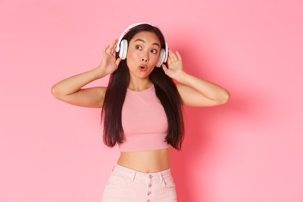 Portrait expressive young woman with headphones listening music