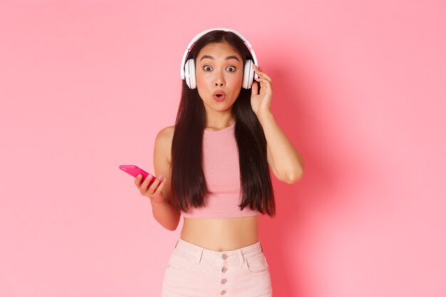 Portrait expressive young woman with headphones listening music