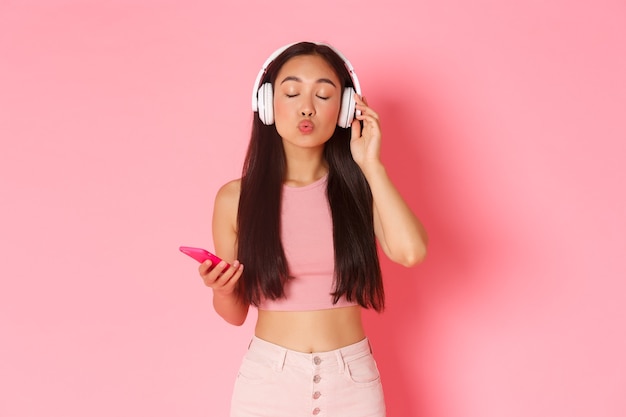 Portrait expressive young woman with headphones listening music