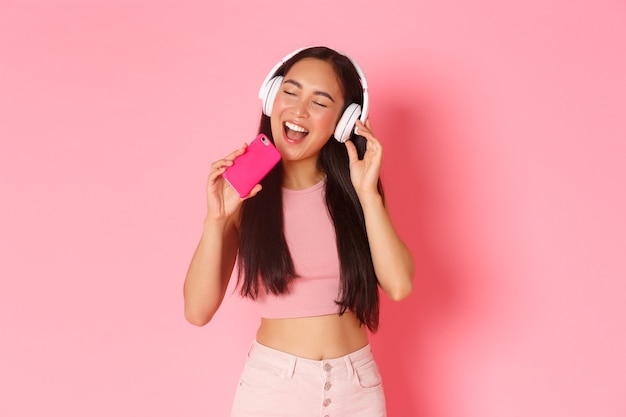 Portrait expressive young woman with headphones listening music