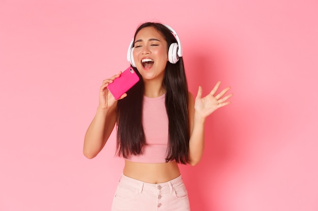 Portrait expressive young woman with headphones listening music