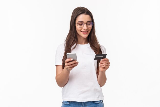 portrait expressive young woman with mobile and credit card